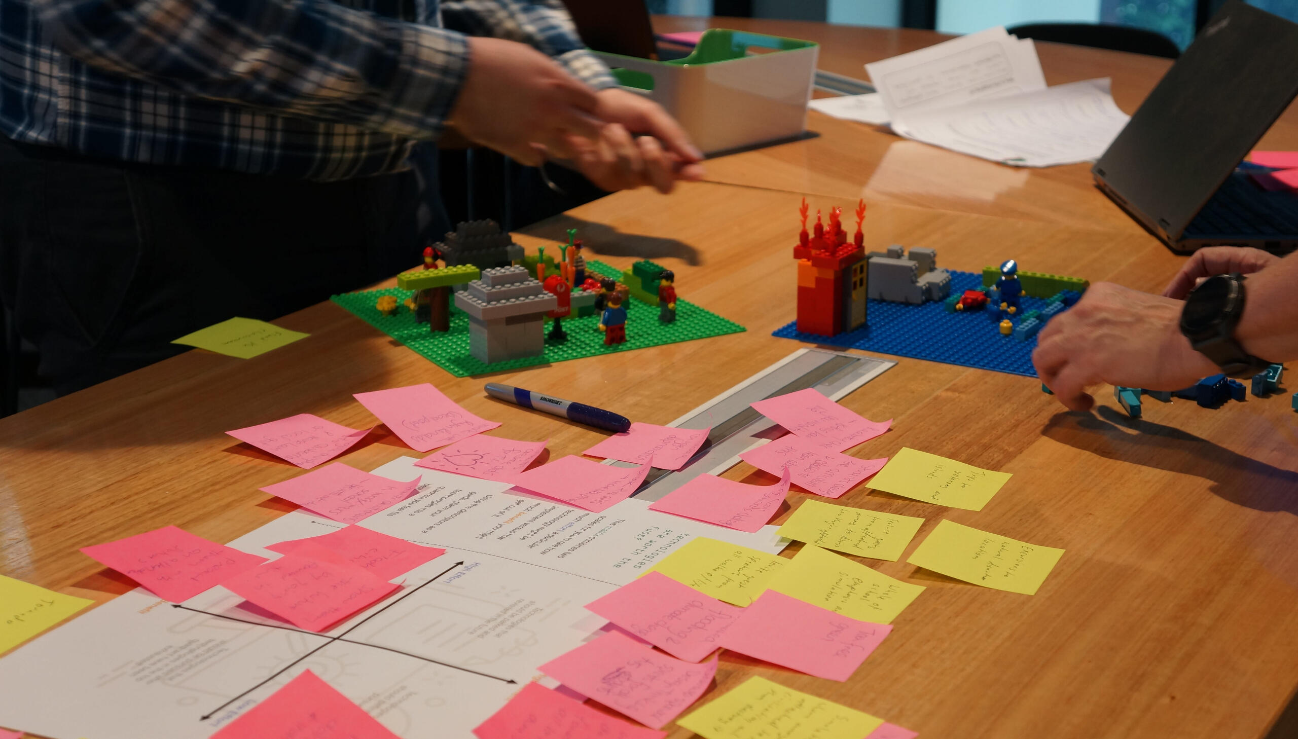 Lego prototype and pink sticky notes from a design thinking professional learning workshop for teachers